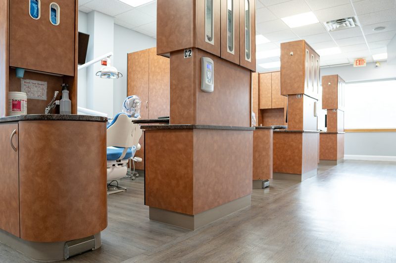 A row of dental operatories with wood cabinetry in the multispecialty office where Arpan Patel, DMD, practices in Langhorne, Pennsylvania.